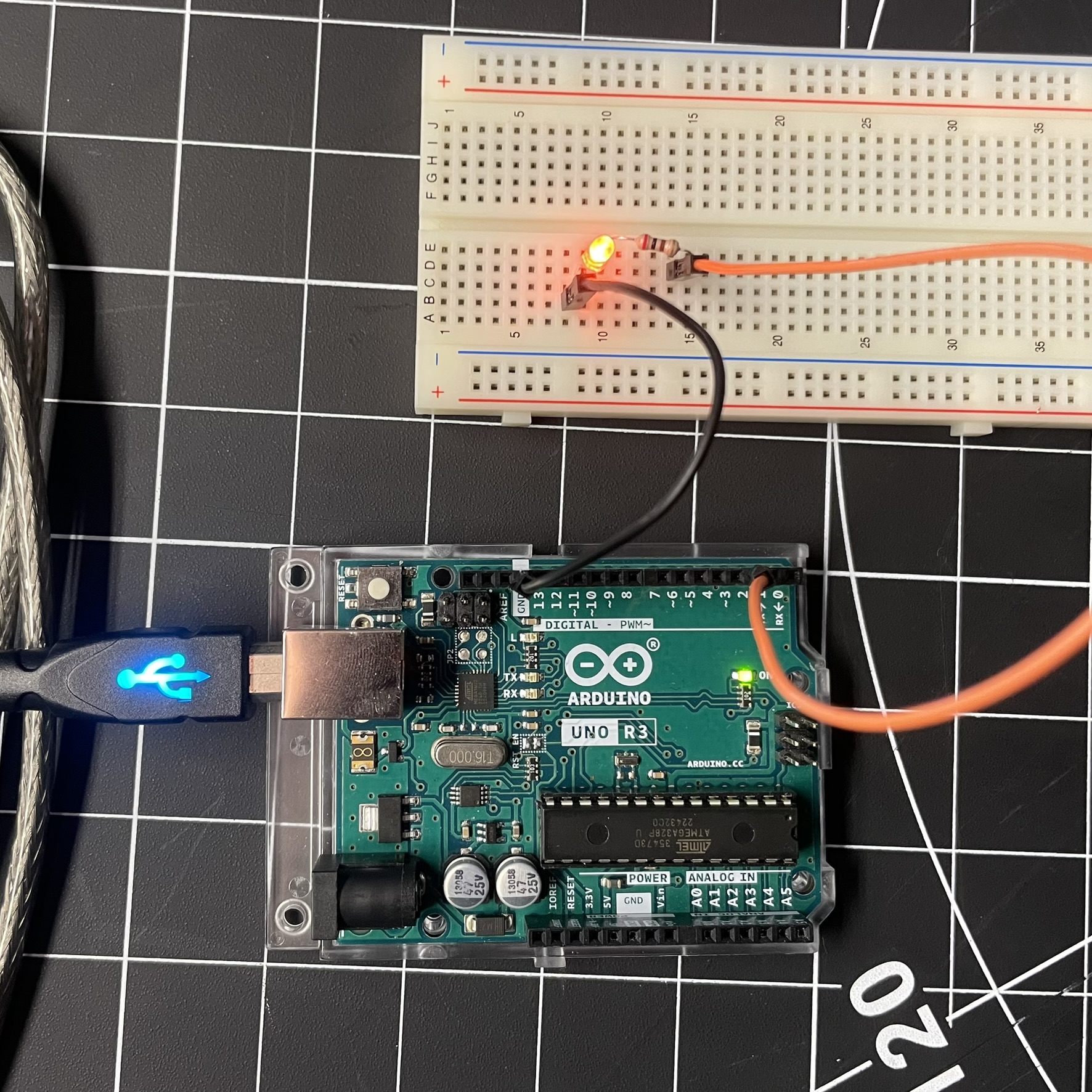 This is the Arduino board connected with the same light and wires as the last image, though here the only difference is the small bridge connector, removing the direct connection from the wires to the light, adding an extra element to further the circuit.