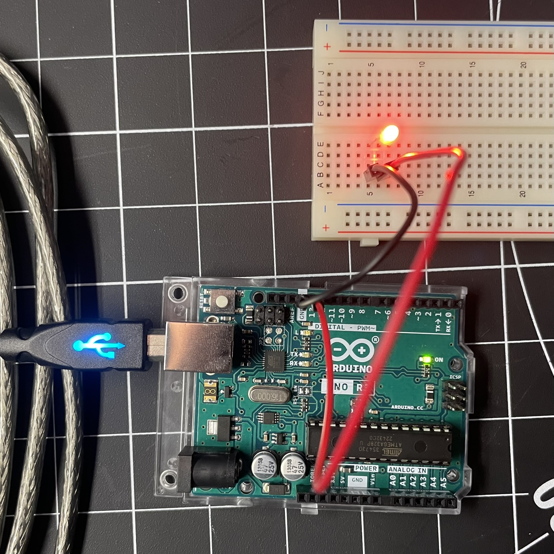 This is an image of the Arduino board connected to a bread board, using wires and a light to create a simple circuit. This is the start to showing how the Arduino board can be combined with different elements to bring what the code is asking into a physical form.
